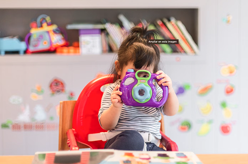 Young child exploring with a toy camera at Montezuny Montessori microschool in Florida, combining play and early learning.