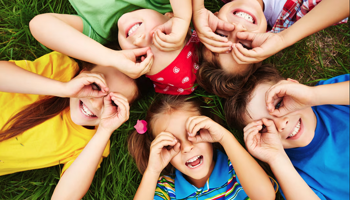 Happy kids playing outdoors at Montezuny Montessori microschool in Polk County, Florida, during early childhood education activities.